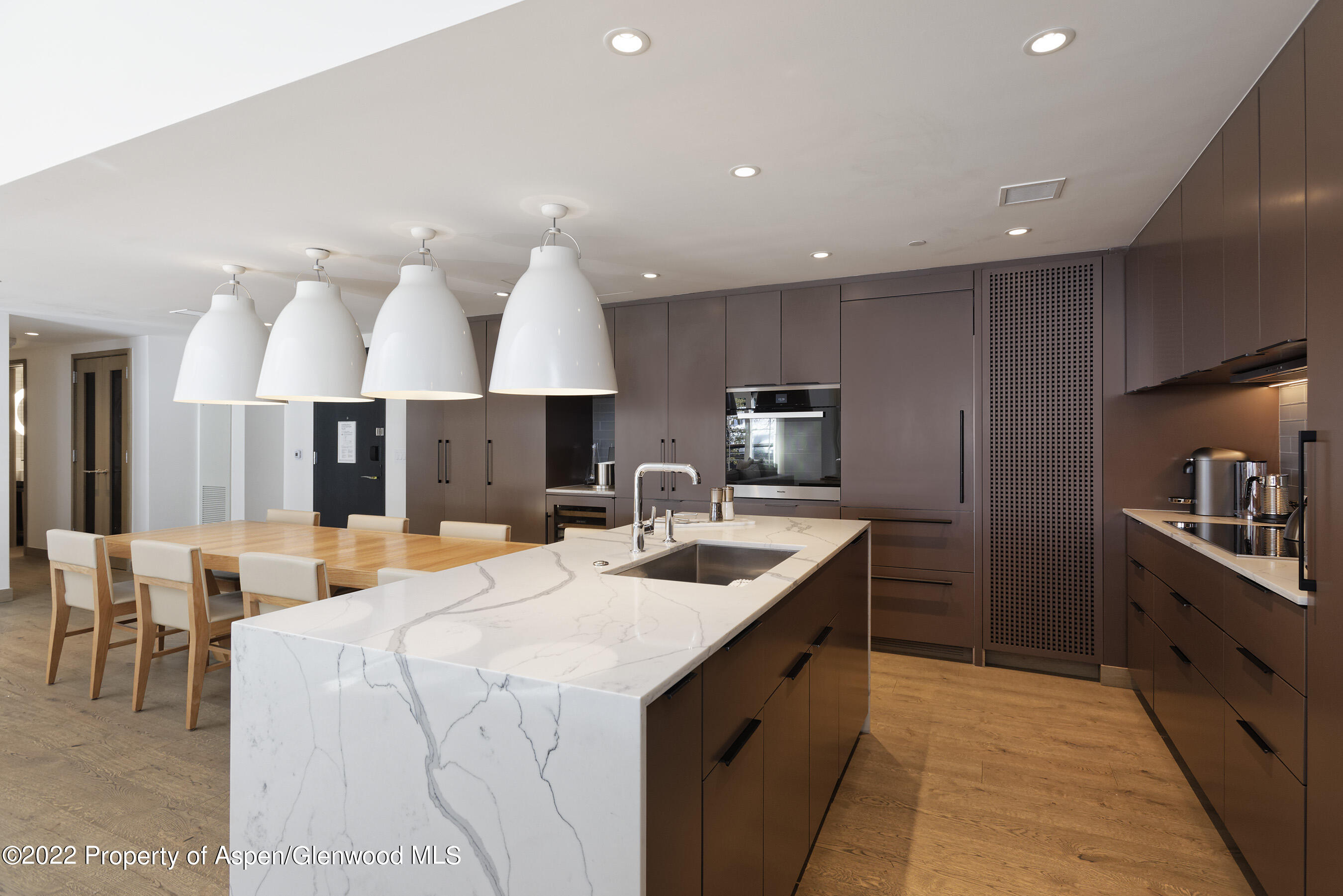 550 South Spring Street, Unit 392 Aspen, CO 81611 - Photo 9 of 41 a kitchen with stainless steel appliances kitchen island granite countertop a sink and a stove