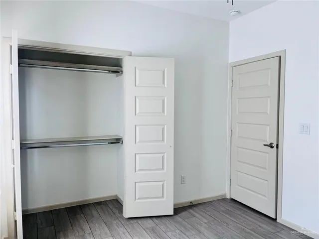 a view of walk in closet with empty racks