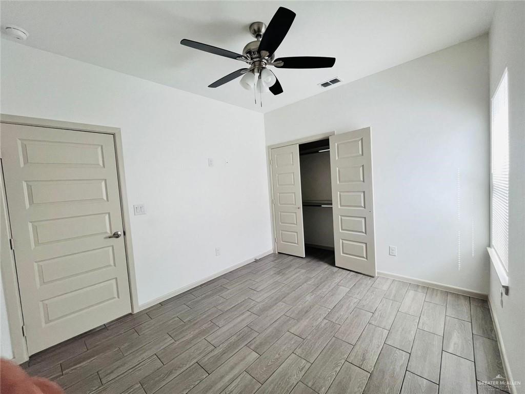 12610 North 33rd Lane, Unit 2 Edinburg, TX 78541 - Photo 7 of 11 wooden floor in an empty room with a window