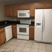 941 Homestead Road South Lehigh Acres, FL 33974 - Photo 2 of 4 a kitchen with a stove and a microwave