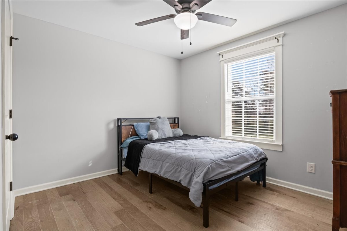 459 Diane Loop White Bluff, TN 37187 - Photo 19 of 35 a bed sitting in a bedroom next to a window and a chandelier fan