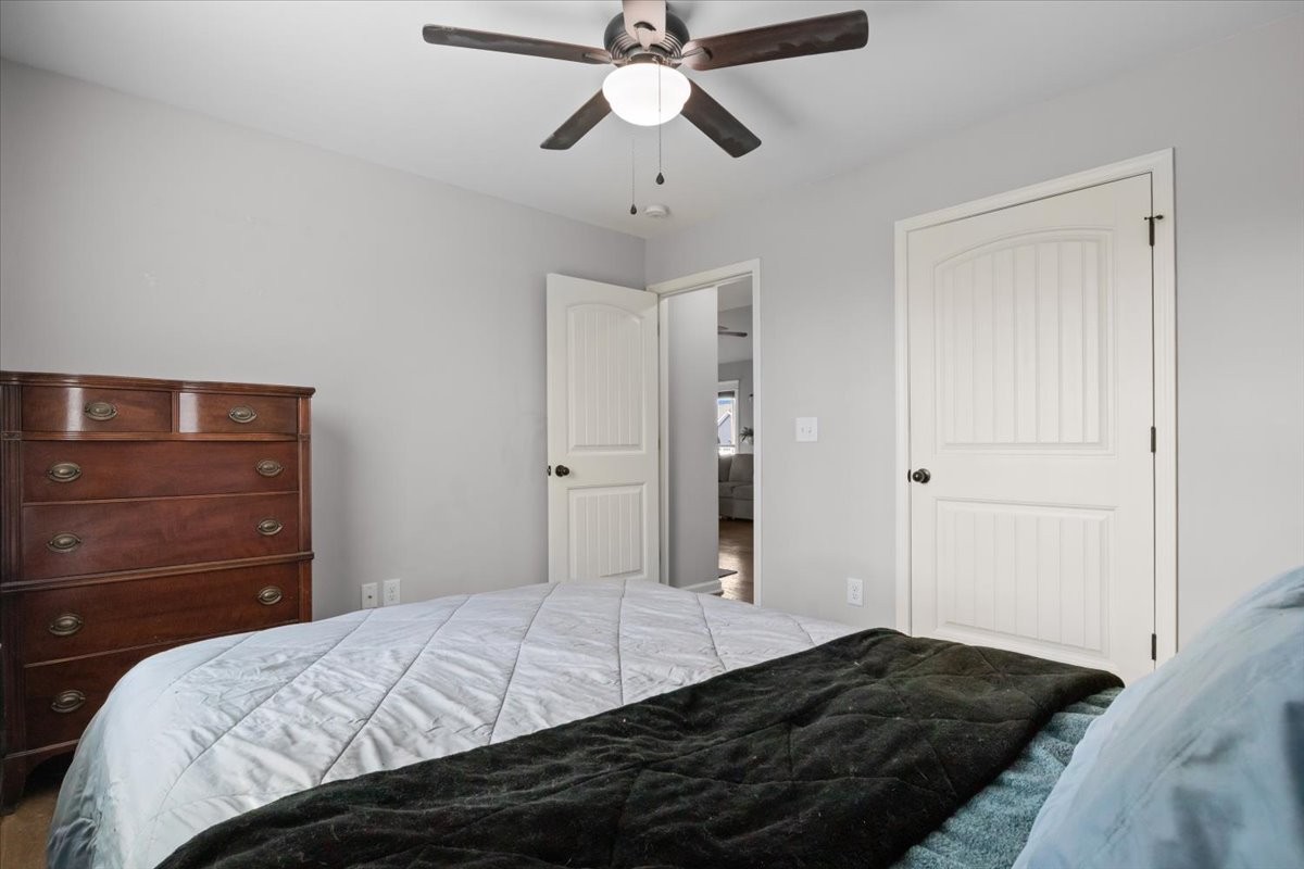 459 Diane Loop White Bluff, TN 37187 - Photo 20 of 35 a bedroom with a bed and a chandelier