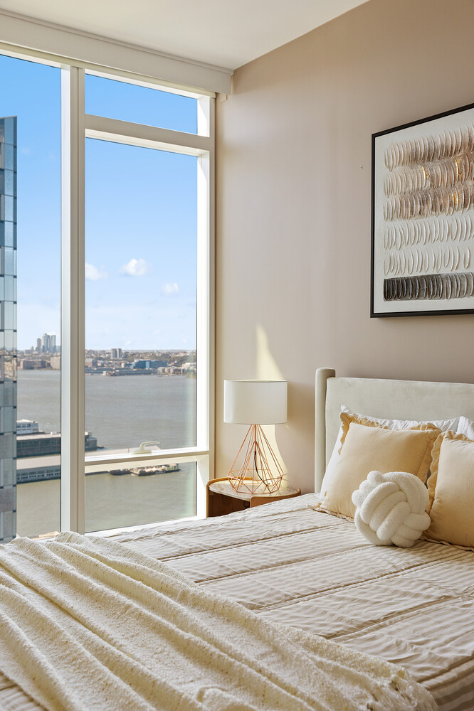 30 Riverside Boulevard, Unit 33A Manhattan, NY 10069 - Photo 12 of 17 a bedroom with a bed and a large mirror