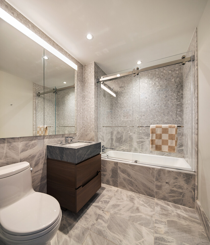 30 Riverside Boulevard, Unit 33A Manhattan, NY 10069 - Photo 13 of 17 a bathroom with a granite countertop bathtub sink vanity mirror and toilet