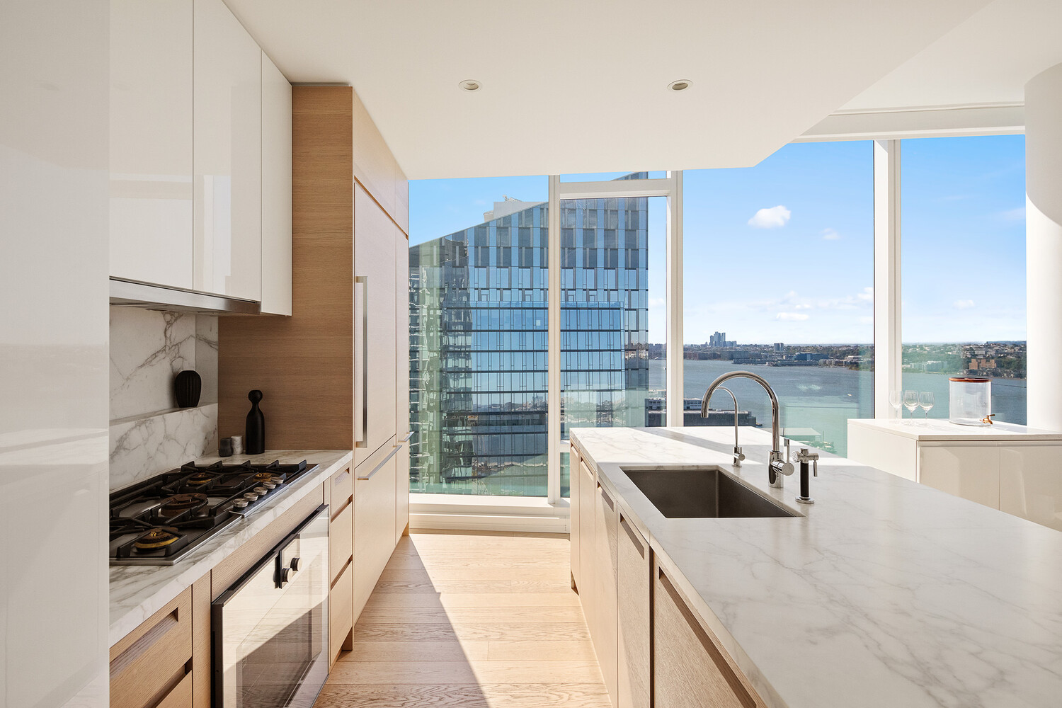 30 Riverside Boulevard, Unit 33A Manhattan, NY 10069 - Photo 5 of 17 a kitchen with a stove a sink and a wooden cabinets