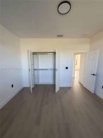 a view of empty room with ceiling fan