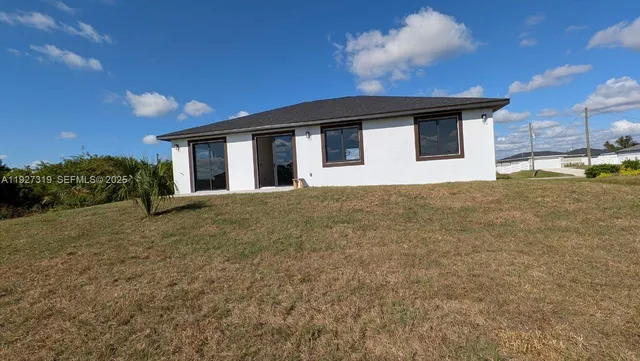 a view of a house with a backyard