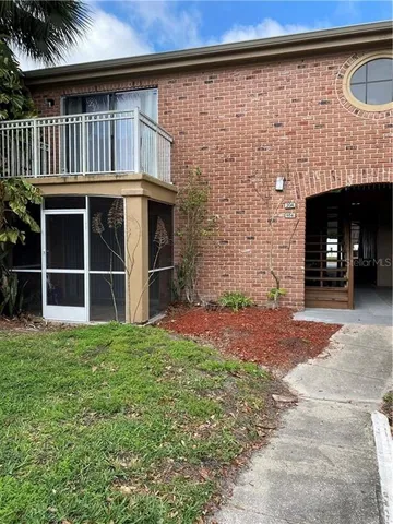 a view of a backyard with door and wooden floor