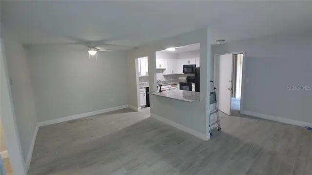 a view of a kitchen with wooden floor