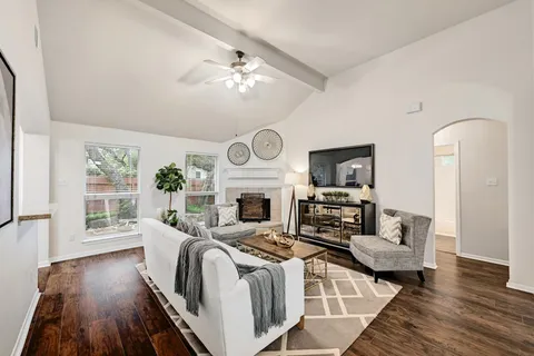 a living room with furniture fireplace and flat screen tv