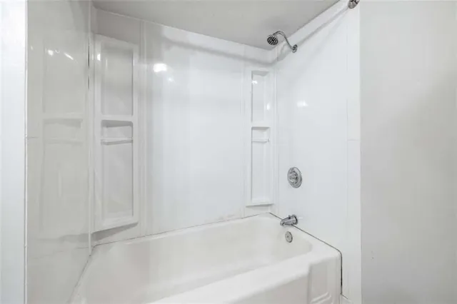 an entryway to room with wooden floor and a rug