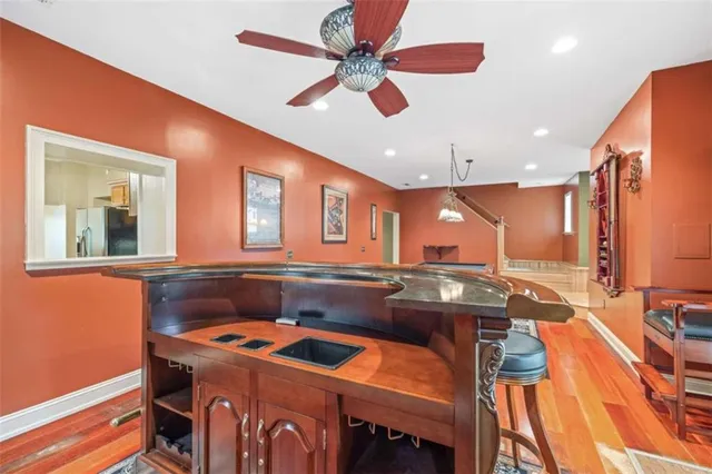 a living room with furniture pool table and a rug