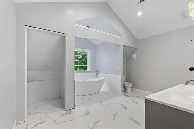 a white bath tub sitting next to a toilet