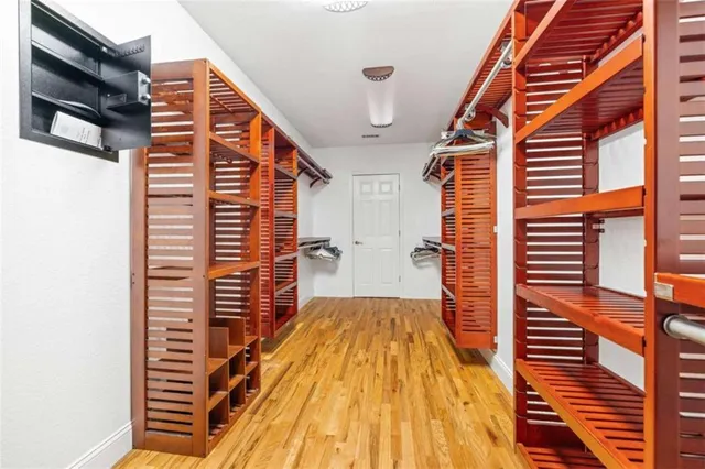 a view of a room with wooden floor and a window