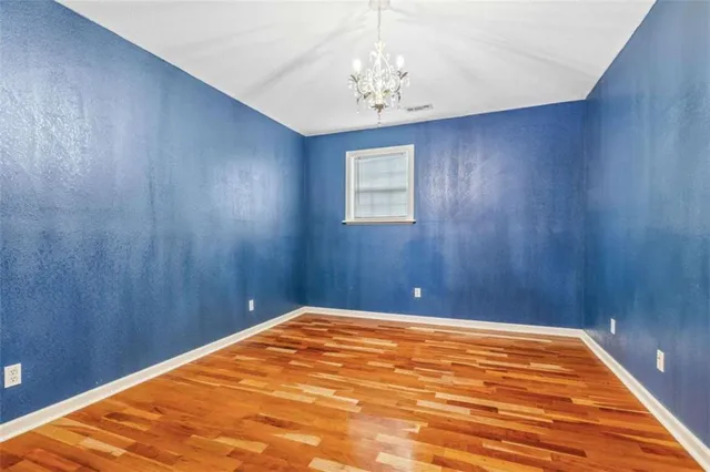 a view of a bedroom with wooden floor and bedroom