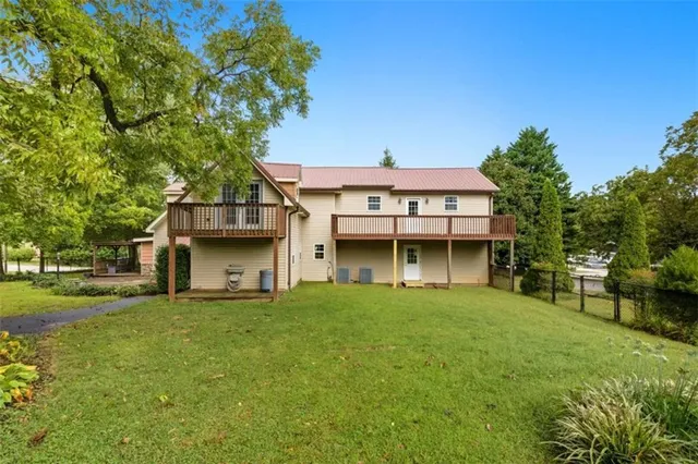 a backyard of a house with table and chairs