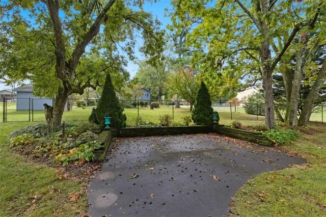 a view of a backyard with table and chairs under an umbrella