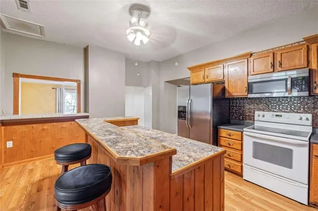 a kitchen with a stove and a refrigerator