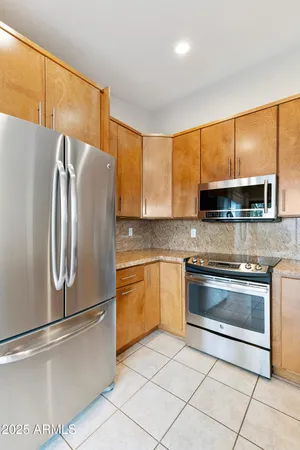 a kitchen with stainless steel appliances granite countertop a refrigerator stove and microwave