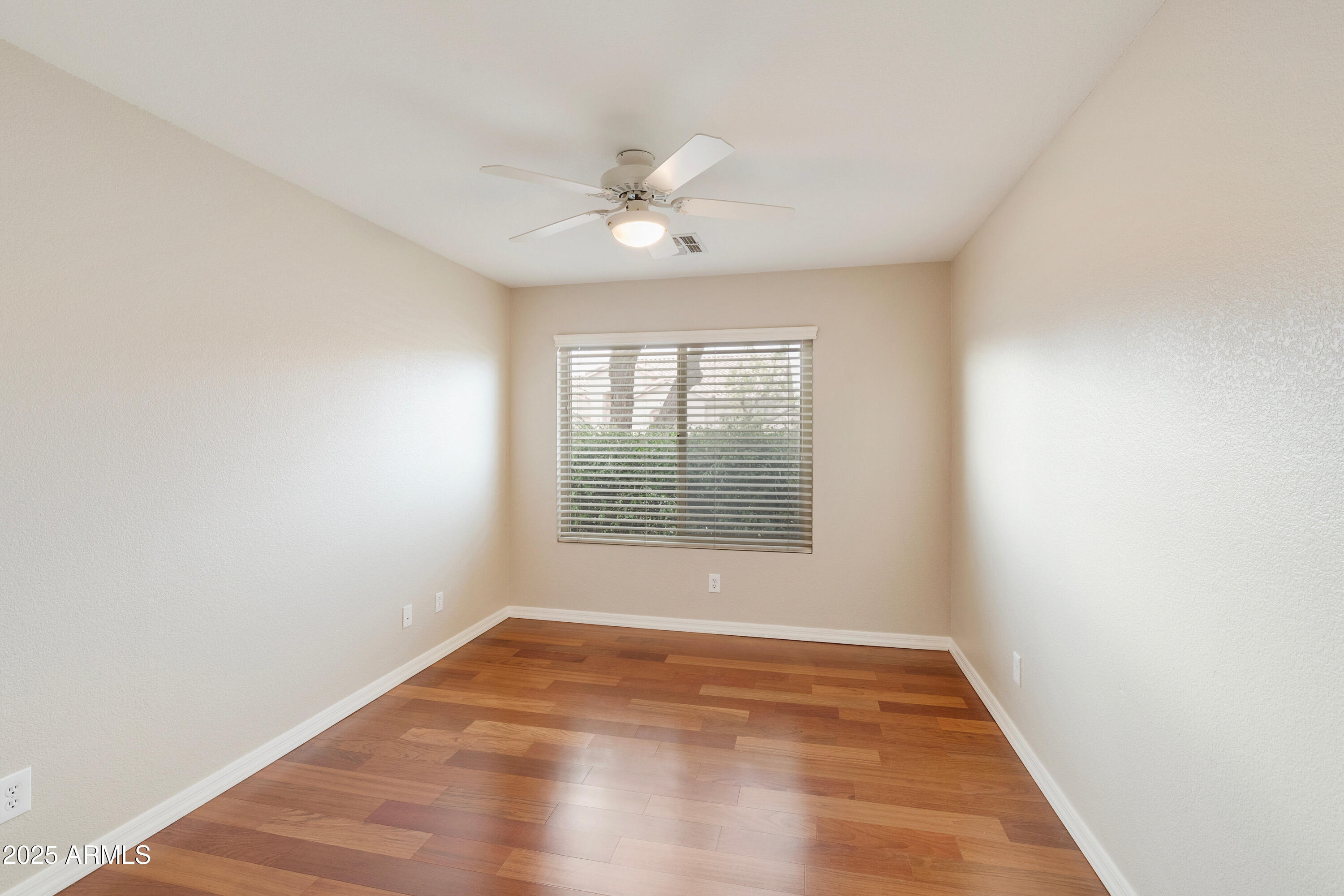 4300 East Cassia Lane Gilbert, AZ 85298 - Photo 17 of 54 an empty room with wooden floor and windows
