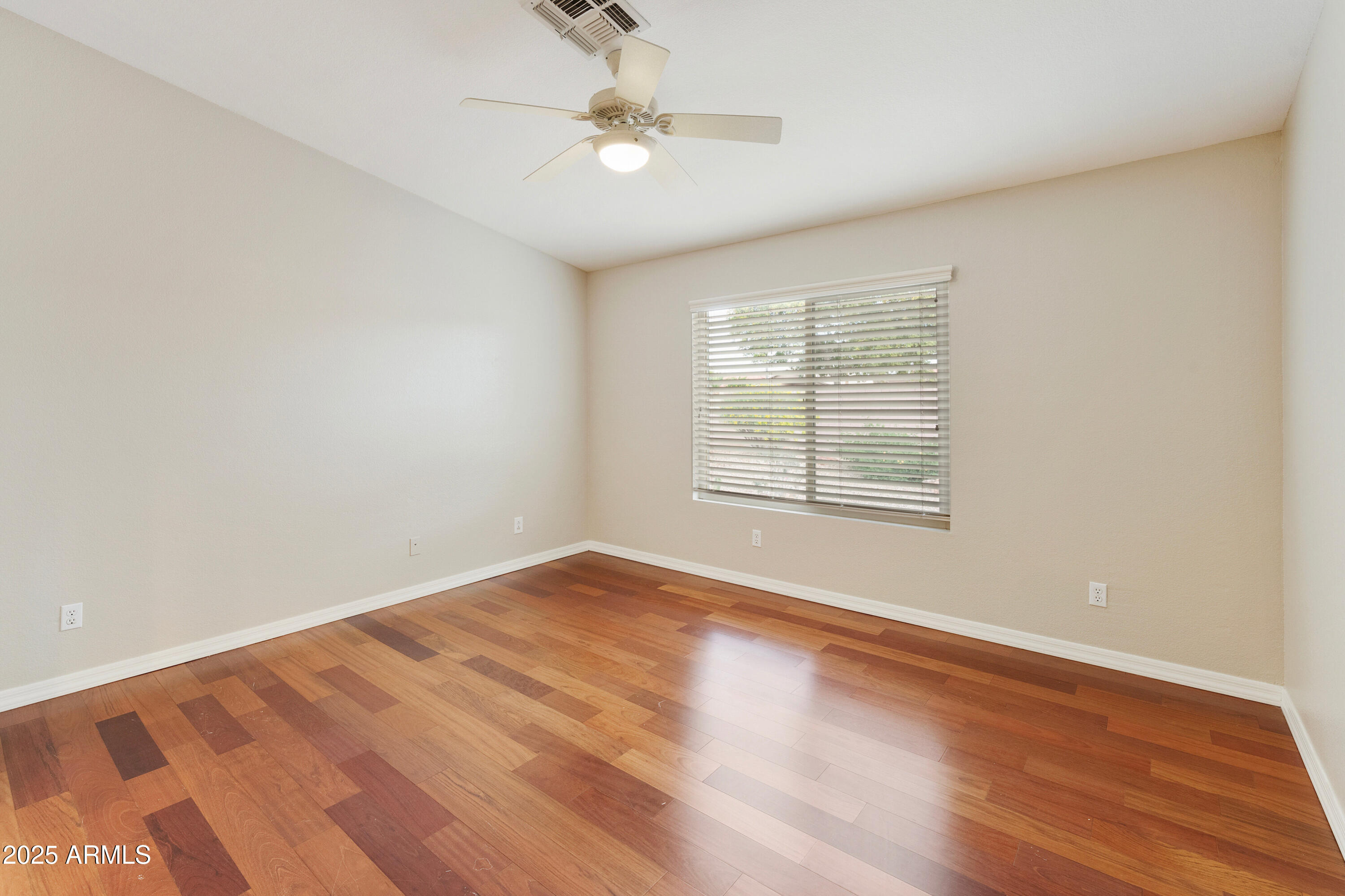 4300 East Cassia Lane Gilbert, AZ 85298 - Photo 19 of 54 wooden floor in an empty room with a window