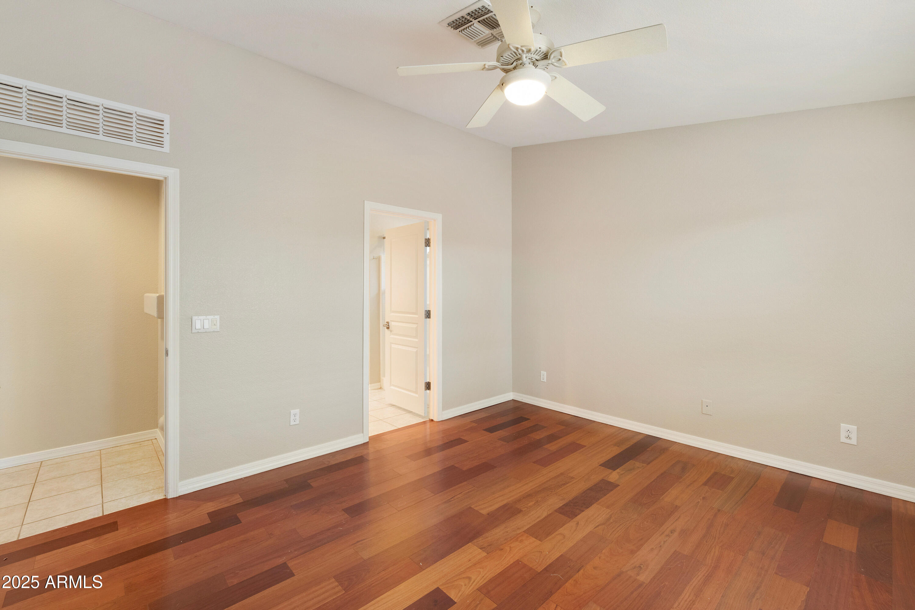 4300 East Cassia Lane Gilbert, AZ 85298 - Photo 20 of 54 an empty room with wooden floor and fan