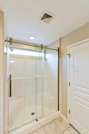 a bathroom with a glass shower door