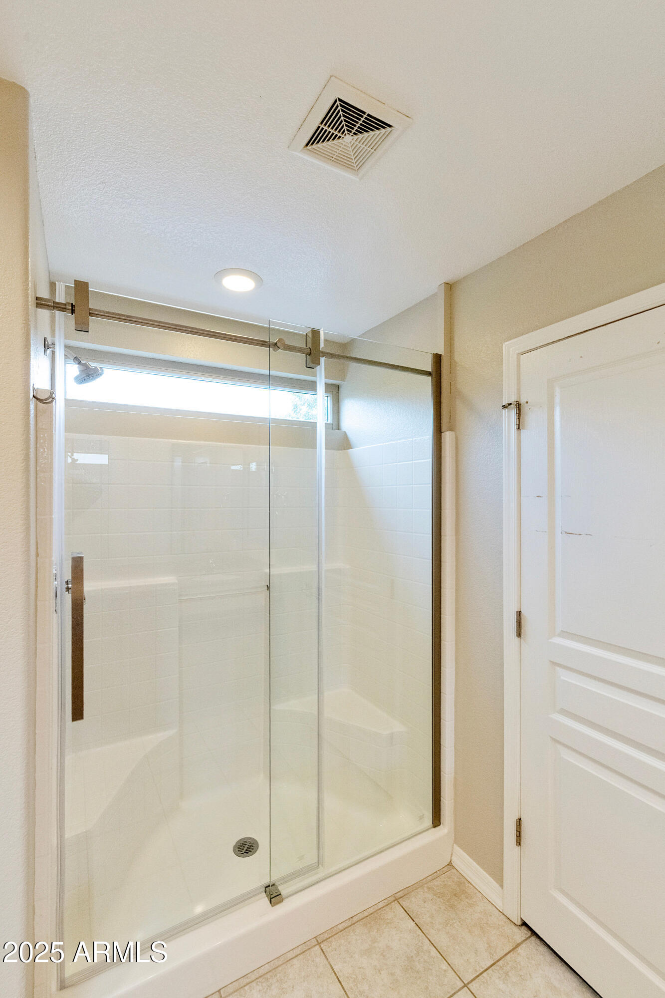4300 East Cassia Lane Gilbert, AZ 85298 - Photo 23 of 54 a bathroom with a glass shower door