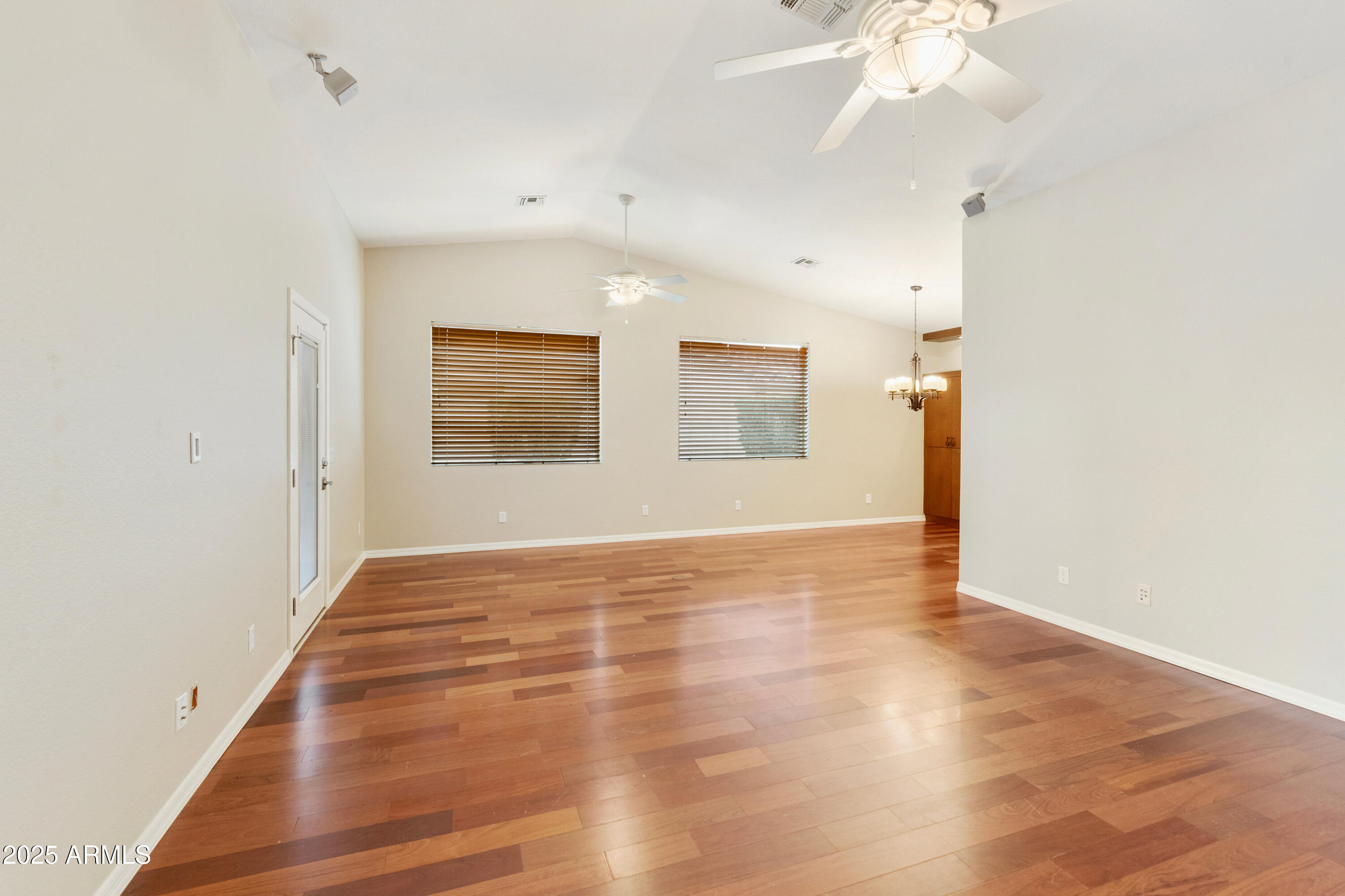 4300 East Cassia Lane Gilbert, AZ 85298 - Photo 6 of 54 a view of an empty room with wooden floor and a window
