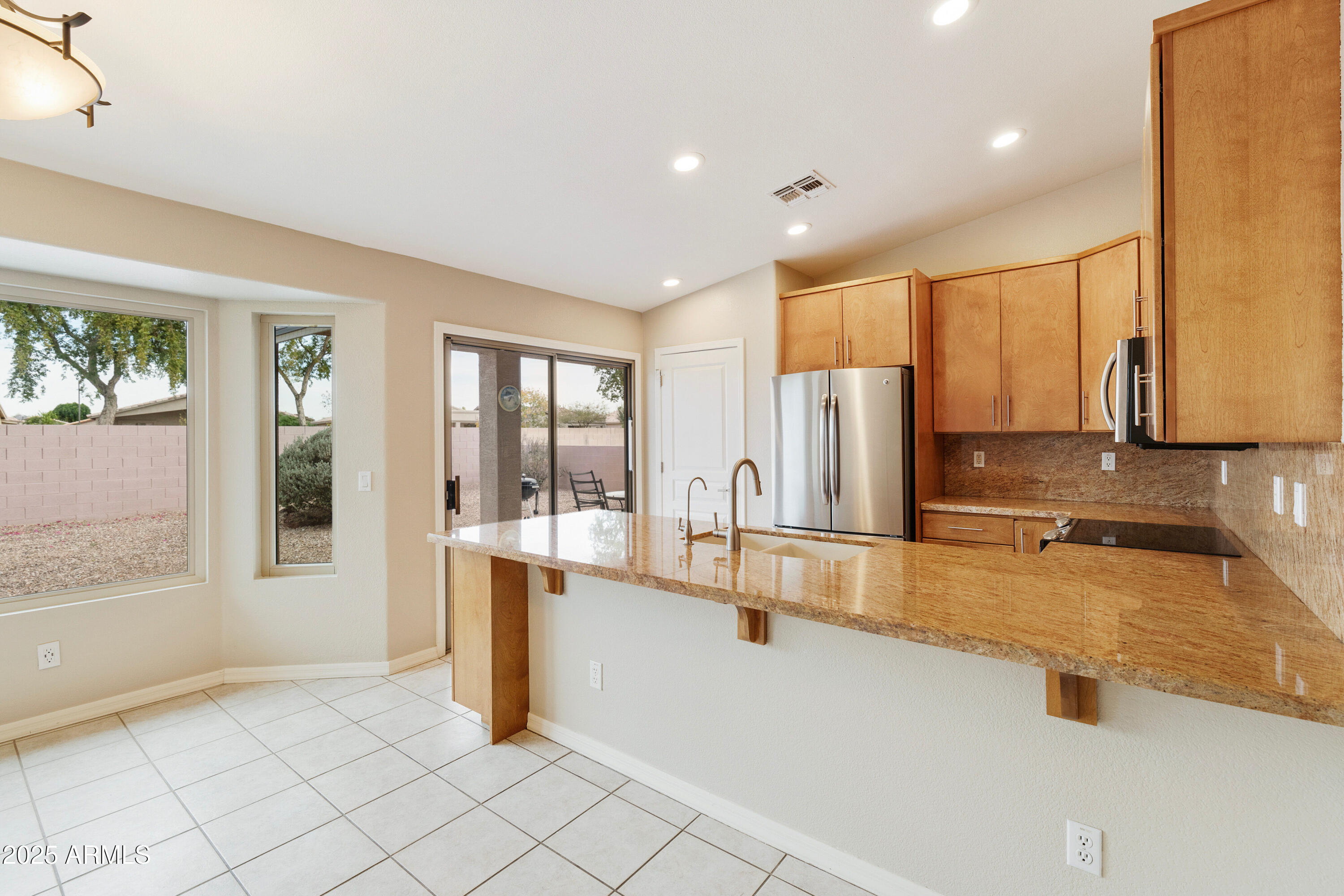 4300 East Cassia Lane Gilbert, AZ 85298 - Photo 9 of 54 a kitchen with stainless steel appliances granite countertop a refrigerator and a sink