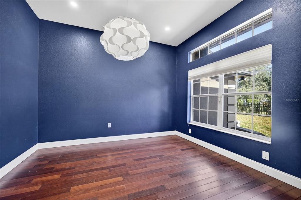 5637 Rhapsody Avenue North Port, FL 34288 - Photo 11 of 34 a view of an empty room with wooden floor and a window