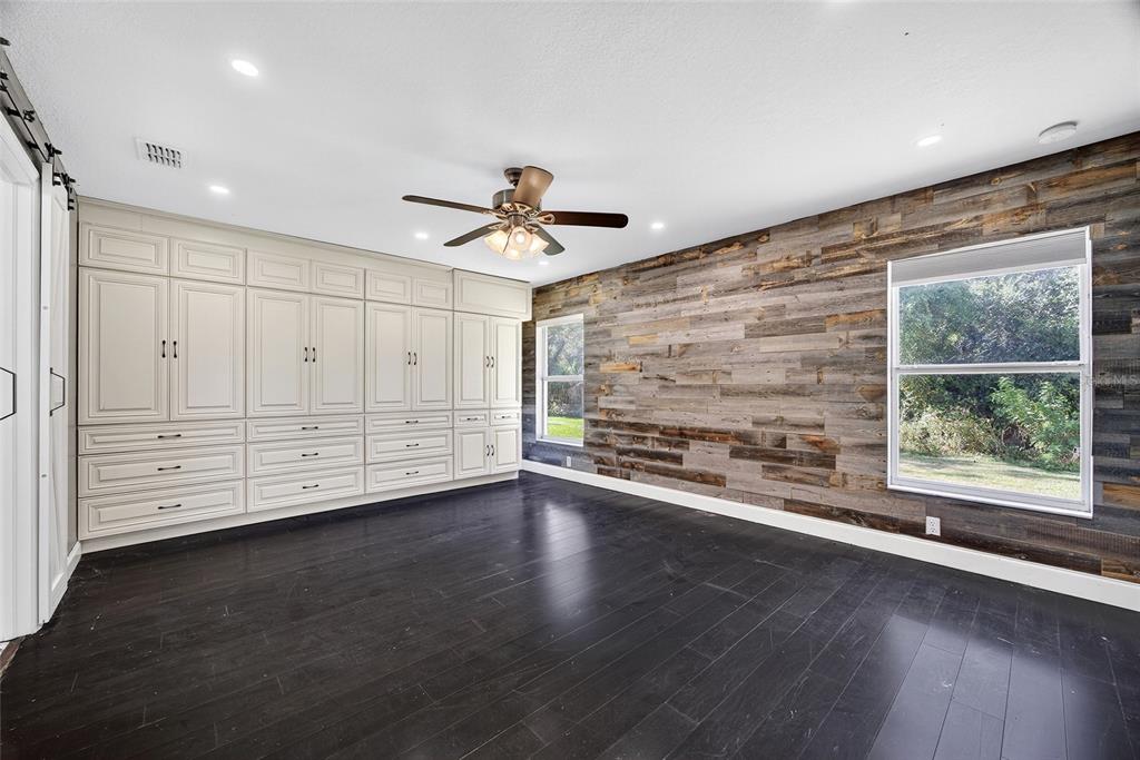 5637 Rhapsody Avenue North Port, FL 34288 - Photo 13 of 34 a view of an empty room with a window and wooden floor