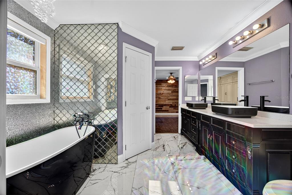 5637 Rhapsody Avenue North Port, FL 34288 - Photo 16 of 34 a large bathroom with a double vanity sink a mirror and a shower