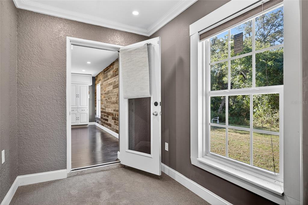 5637 Rhapsody Avenue North Port, FL 34288 - Photo 17 of 34 a view of an empty room with a fireplace and a window