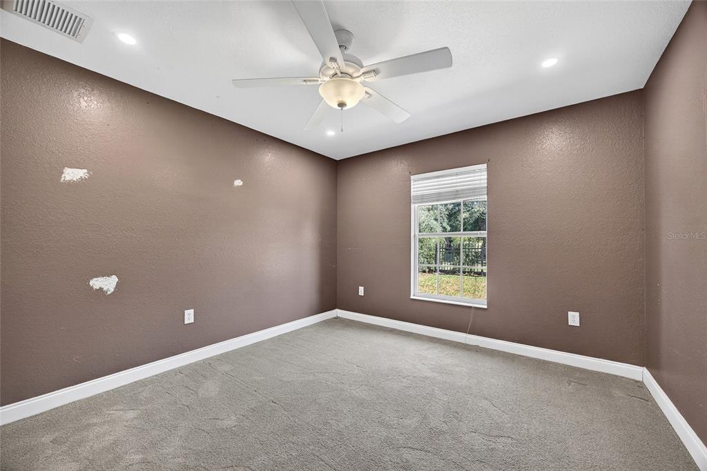 5637 Rhapsody Avenue North Port, FL 34288 - Photo 21 of 34 an empty room with windows and fan