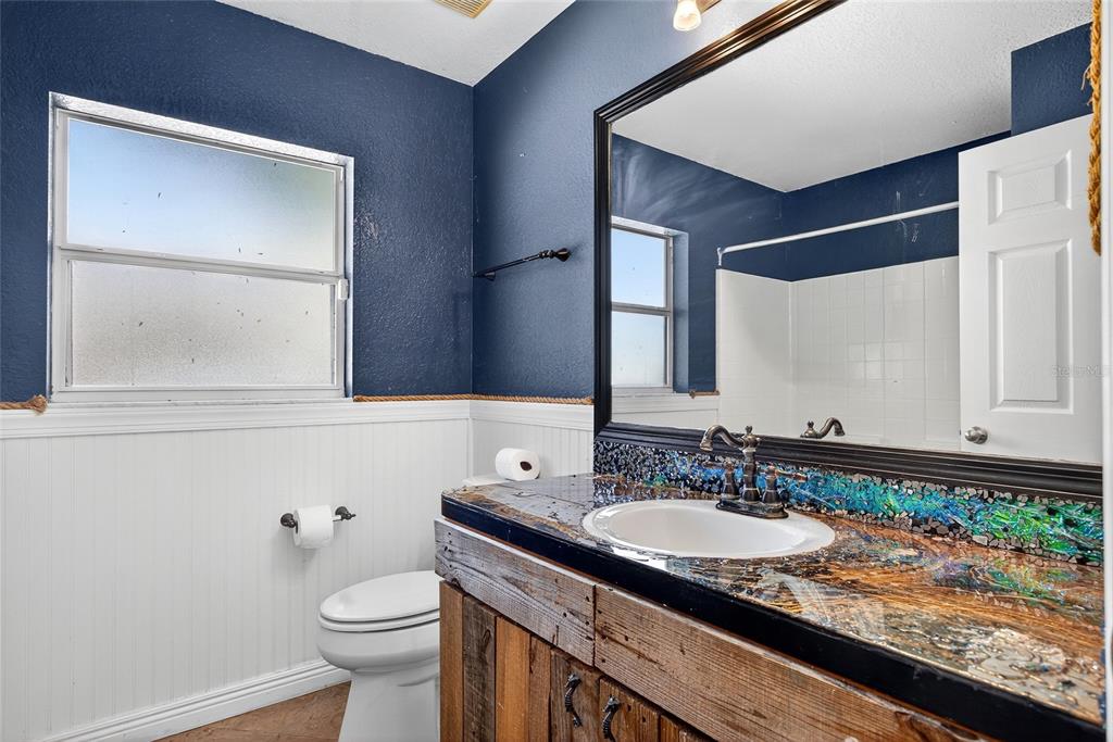 5637 Rhapsody Avenue North Port, FL 34288 - Photo 22 of 34 a bathroom with a granite countertop sink and a toilet