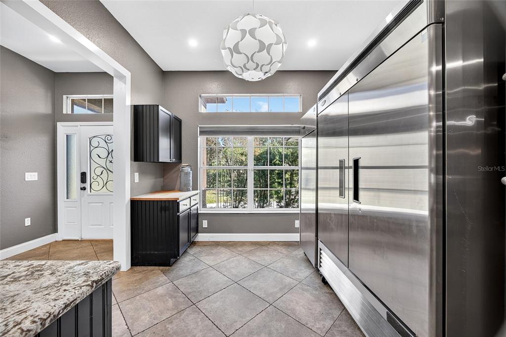 5637 Rhapsody Avenue North Port, FL 34288 - Photo 7 of 34 a open kitchen with granite countertop a refrigerator and a sink