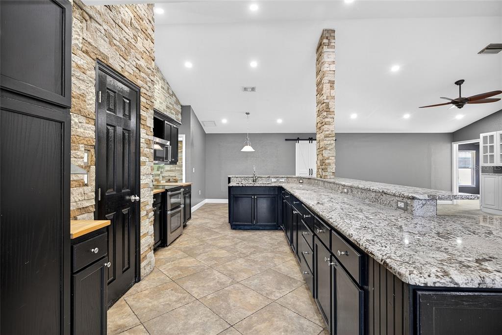 5637 Rhapsody Avenue North Port, FL 34288 - Photo 8 of 34 a kitchen with stainless steel appliances granite countertop a refrigerator a sink and a stove