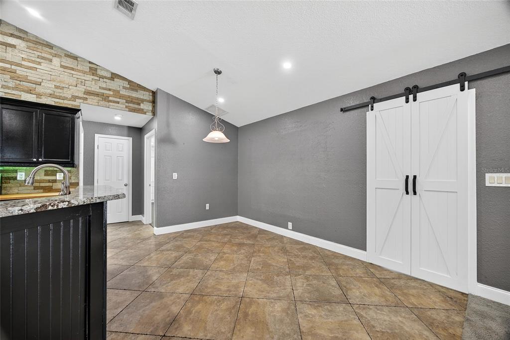 5637 Rhapsody Avenue North Port, FL 34288 - Photo 10 of 34 a view of a livingroom with a walk in closet and wooden floor