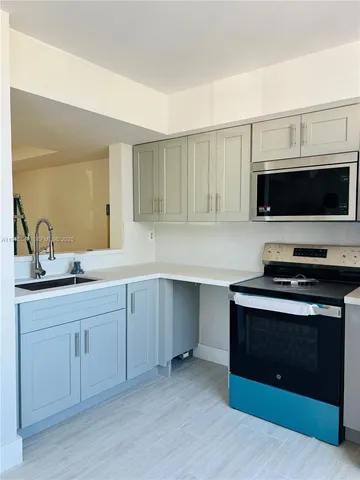 a kitchen with a stove and a sink
