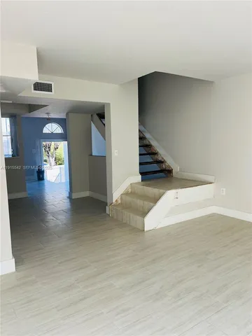a view of a living room with kitchen