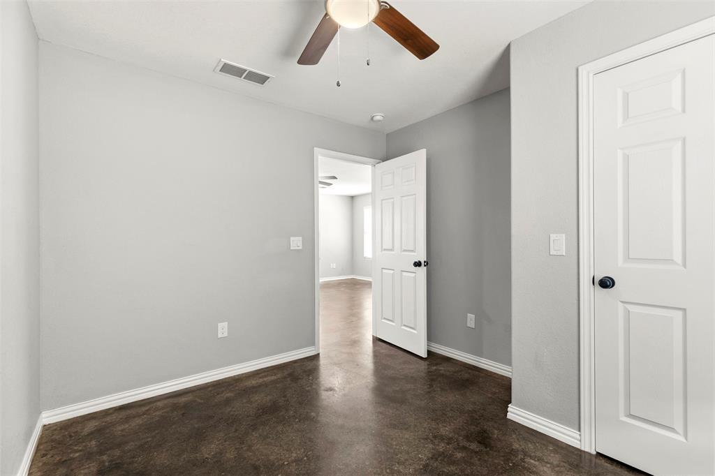 933 Rice Street Denison, TX 75020 - Photo 12 of 21 an empty room with wooden floor and ceiling fan
