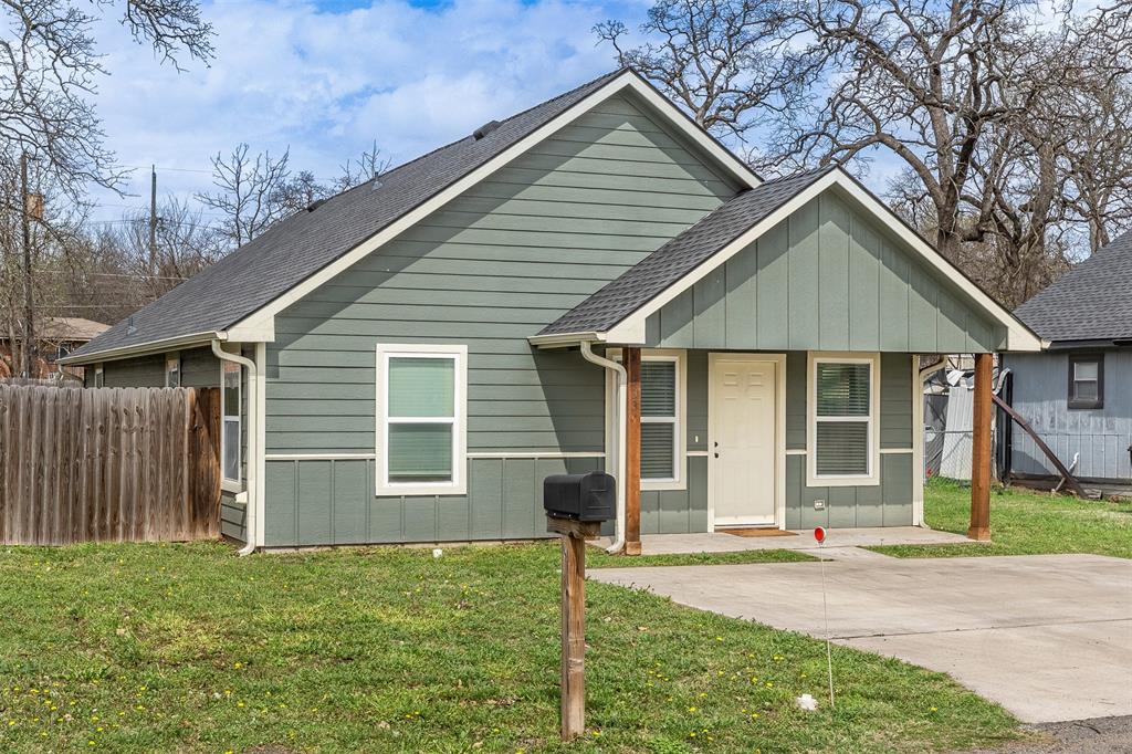 933 Rice Street Denison, TX 75020 - Photo 21 of 21 a front view of a house with a yard and garage