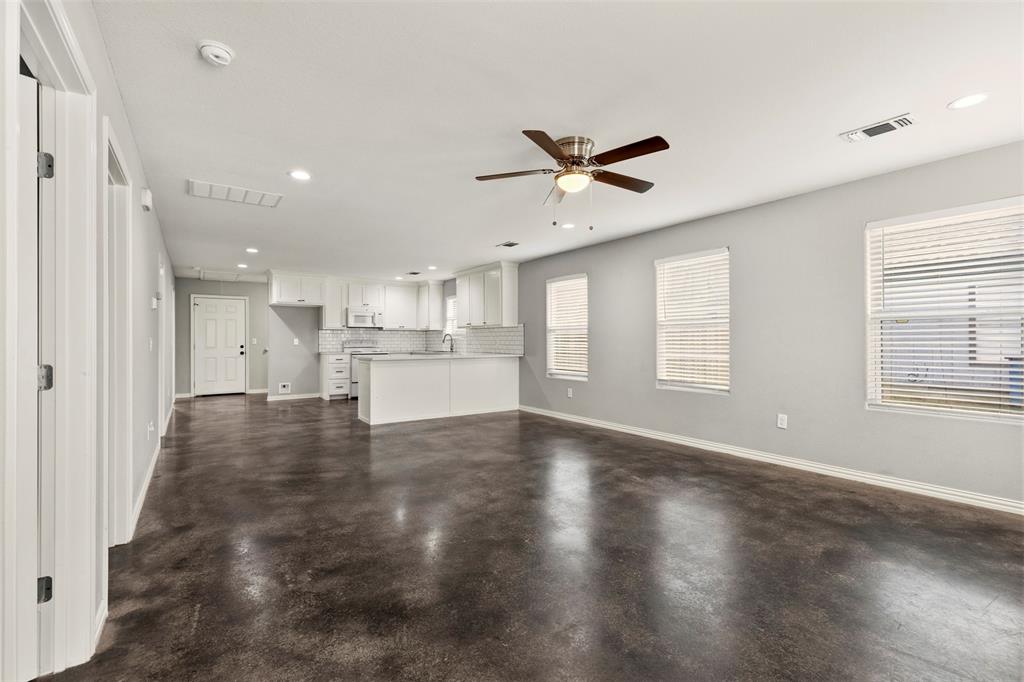 933 Rice Street Denison, TX 75020 - Photo 3 of 21 a view of a kitchen with a sink and a window