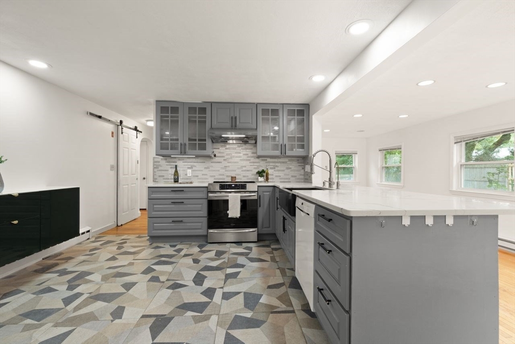 8 Margaret Road Sharon, MA 02067 - Photo 11 of 32 a kitchen with stainless steel appliances granite countertop a stove a sink and a refrigerator
