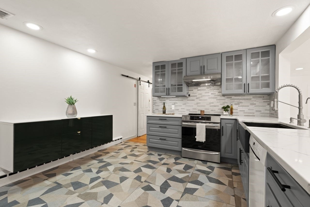 8 Margaret Road Sharon, MA 02067 - Photo 12 of 32 a kitchen with stainless steel appliances granite countertop a stove a sink and a refrigerator