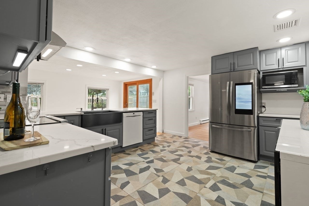 8 Margaret Road Sharon, MA 02067 - Photo 14 of 32 a kitchen with stainless steel appliances granite countertop a refrigerator and a sink