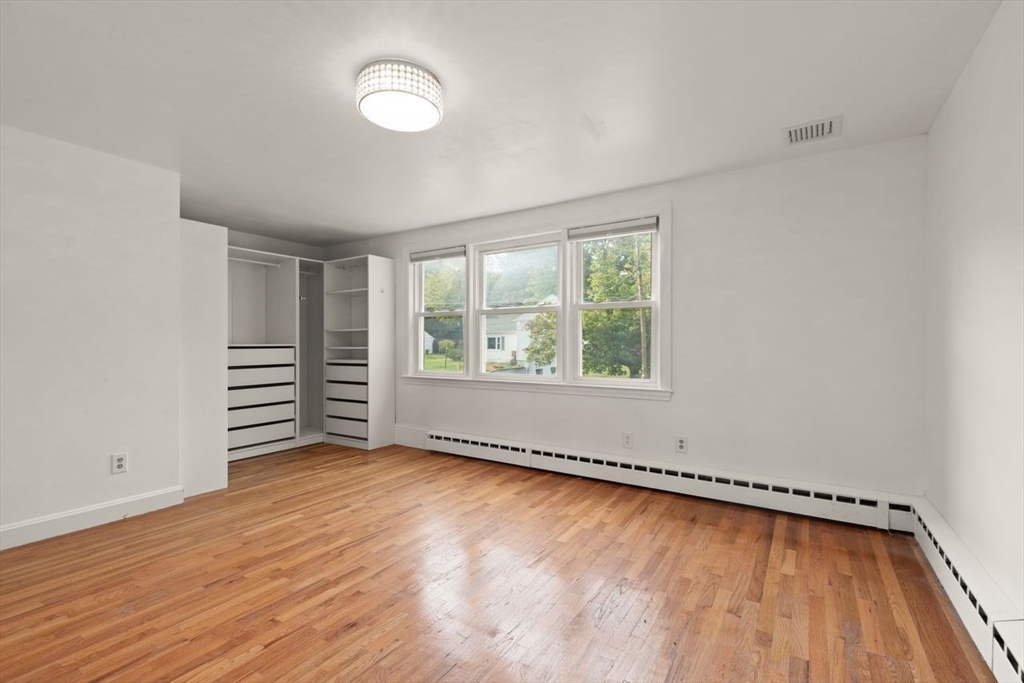 8 Margaret Road Sharon, MA 02067 - Photo 23 of 32 an empty room with wooden floor and windows