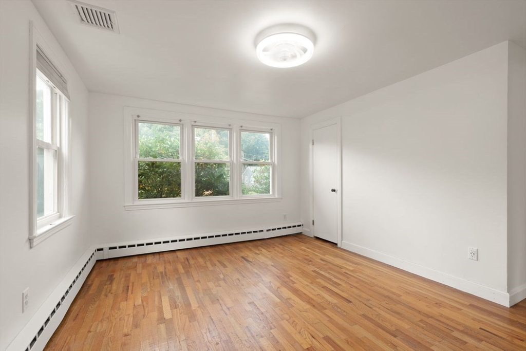 8 Margaret Road Sharon, MA 02067 - Photo 27 of 32 an empty room with wooden floor and windows