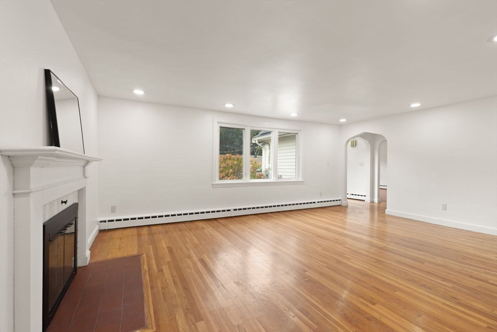 8 Margaret Road Sharon, MA 02067 - Photo 5 of 32 a view of empty room with wooden floor and fireplace